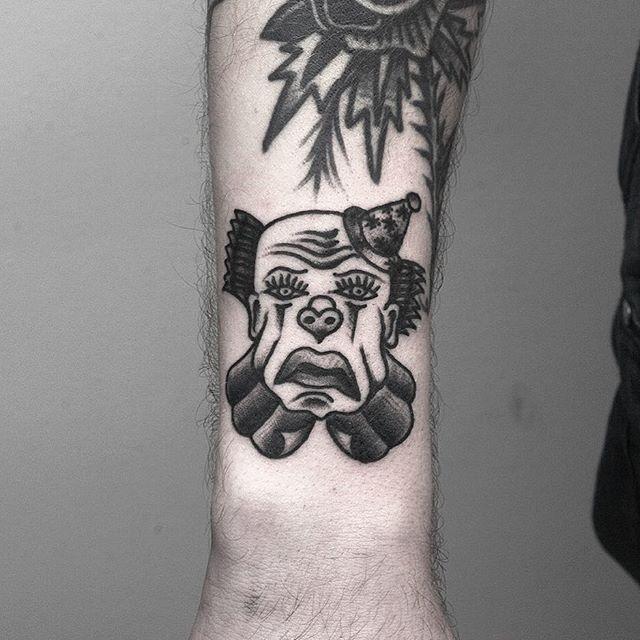 Tattoo of a clown on the forearm for men