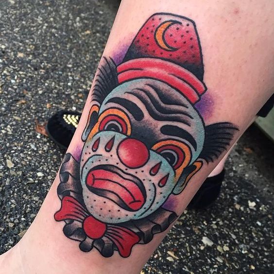 Tattoo of a clown on the shin for women