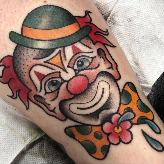 Tattoo of a clown on the thigh