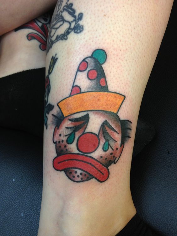 Tattoo of a clown on his shin