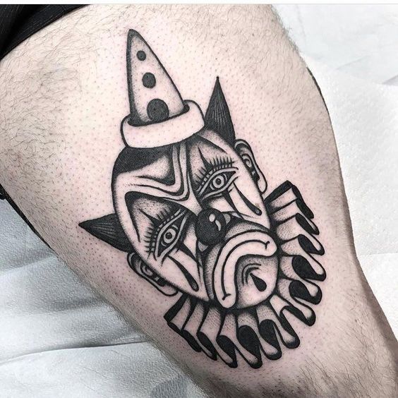 Tattoo of a clown on the thigh