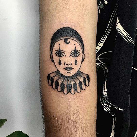 Tattoo of a clown on the forearm