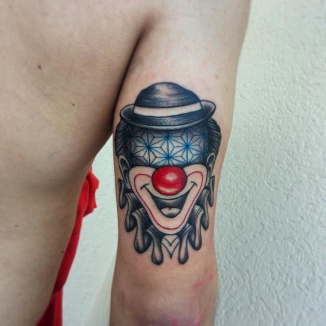 Tattoo of a clown on the shoulder for men