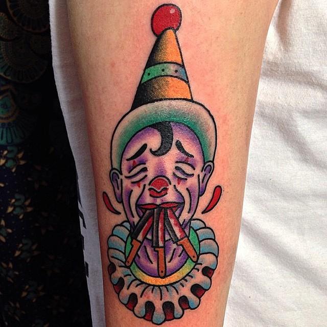 Tattoo of a clown on the shoulder for women