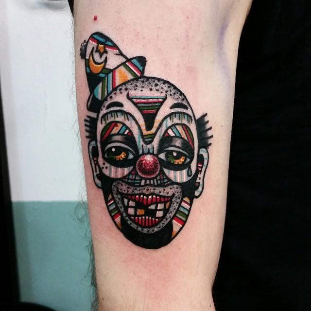 Tattoo of a clown on the shoulder for men