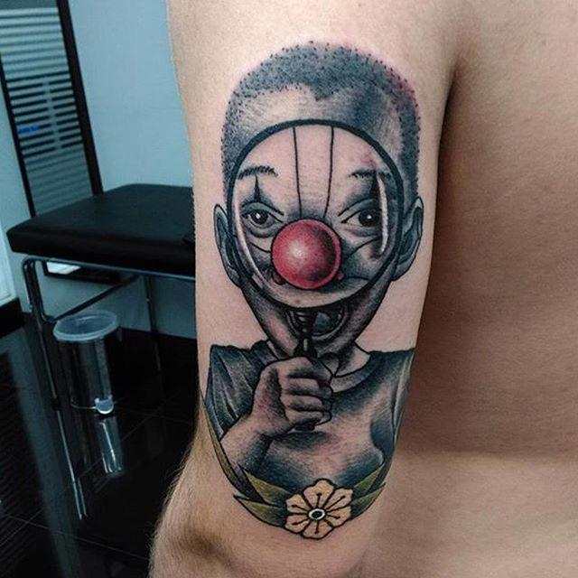 Tattoo of a clown on the shoulder for men