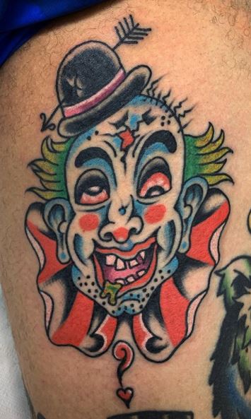 Tattoo of a clown on the hip for men