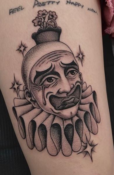 Tattoo of a clown on the hip for women