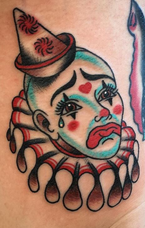 Clown tattoo on leg