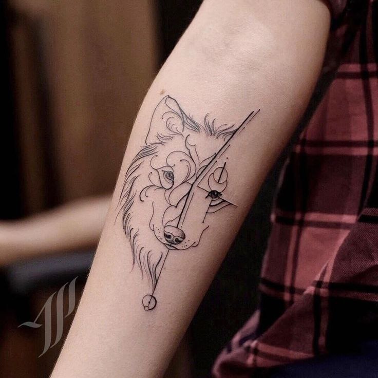 Tattoo of a wolf on the forearm for women