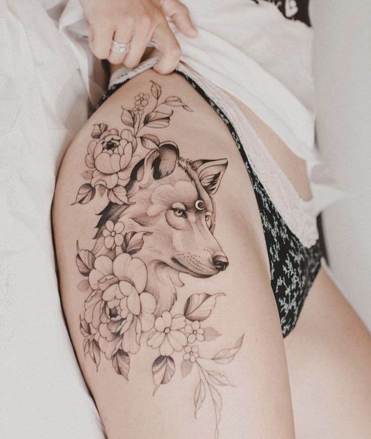 Tattoo of a wolf on the hip for women