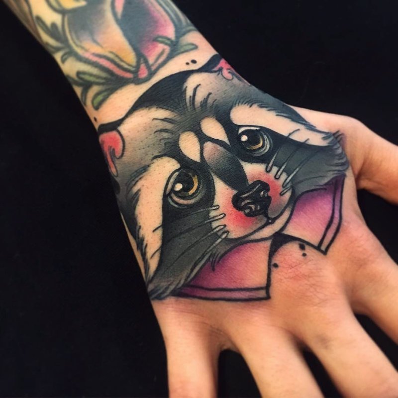 Raccoon tattoo on the hand for men