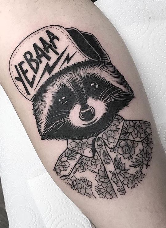 Tattoo of a raccoon on the arm for men