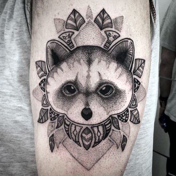 Tattoo of a raccoon on the shoulder for men