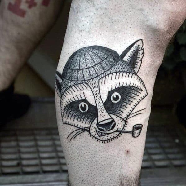 Tattoo of a raccoon on the shin for men