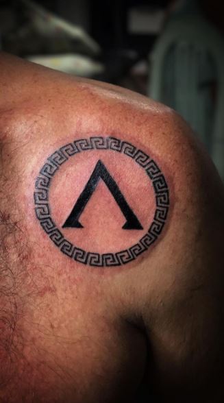 Spartan tattoo on the shoulder blade for men