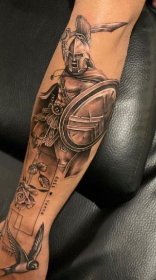 Spartan tattoo on the arm for men