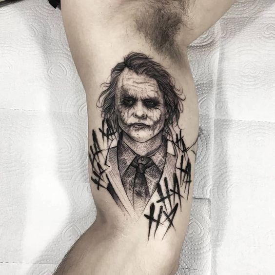 Tattoo of the joker on the shoulder for men