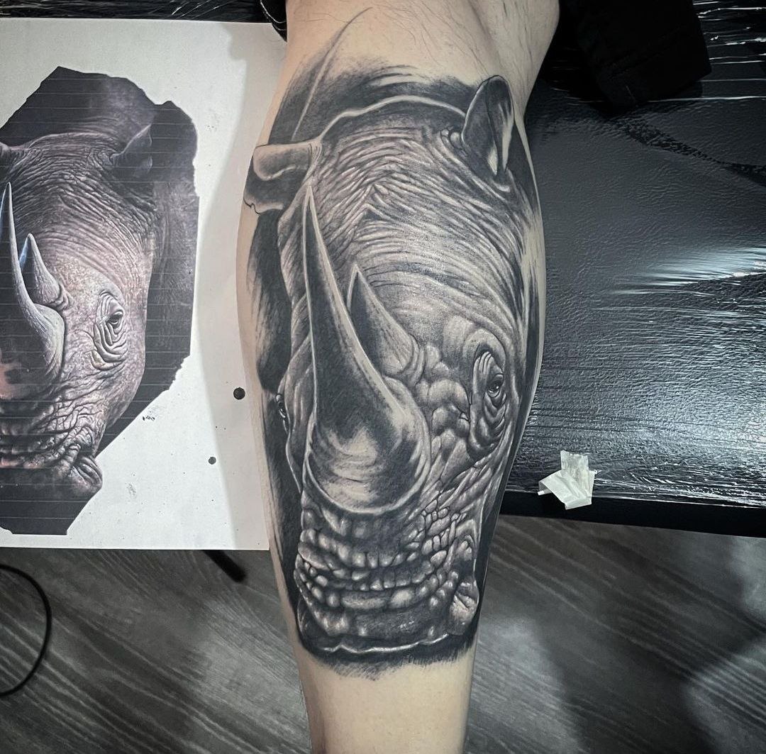 Rhinoceros tattoo on the calf for men