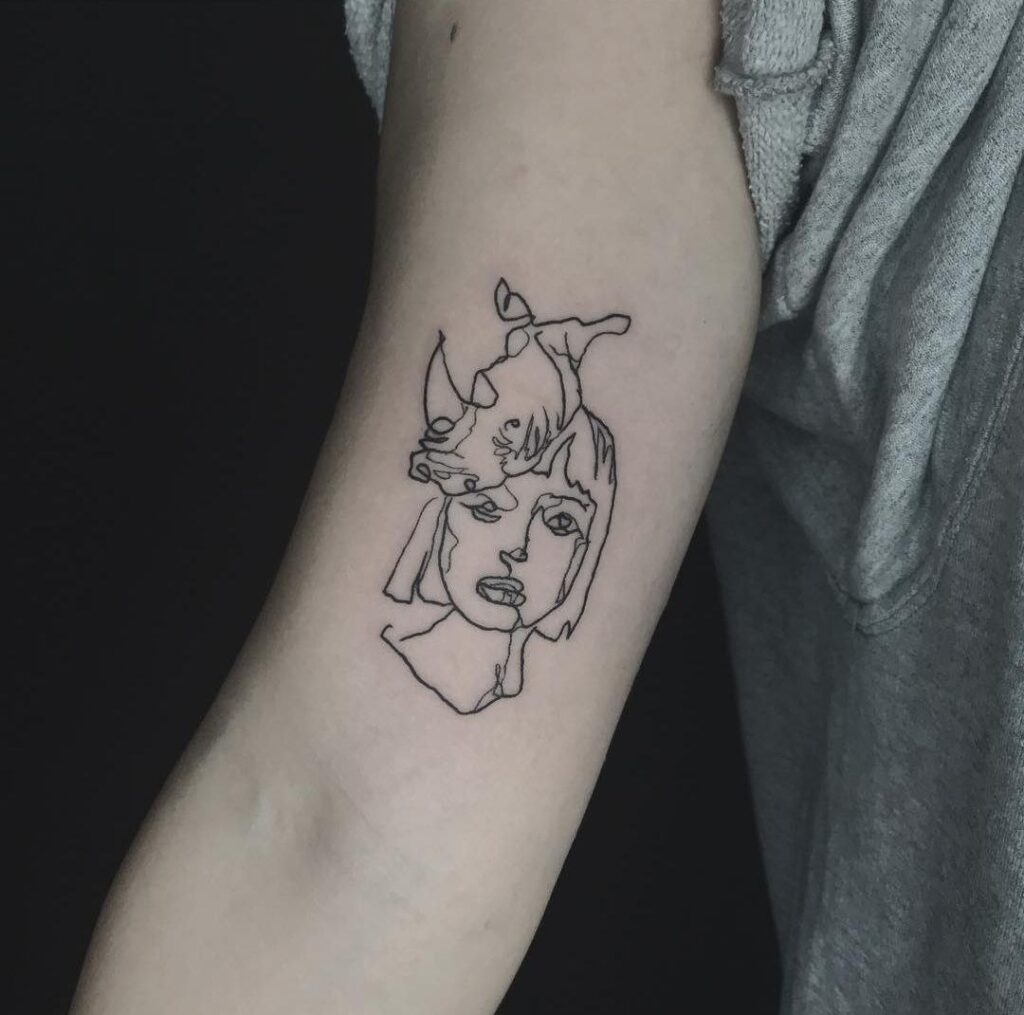 Rhinoceros tattoo on the shoulder for women