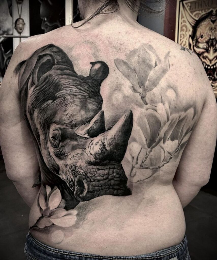 Rhinoceros tattoo on the back for women