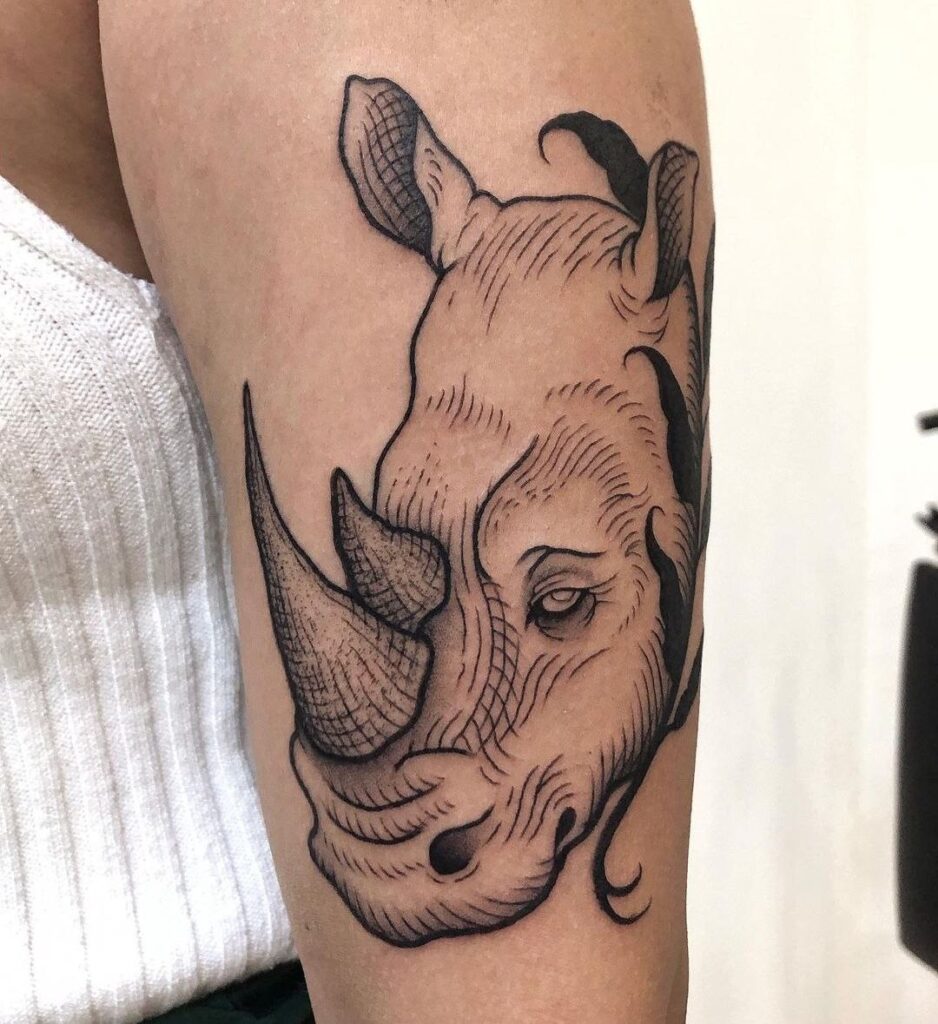 Rhinoceros tattoo on the shoulder for women