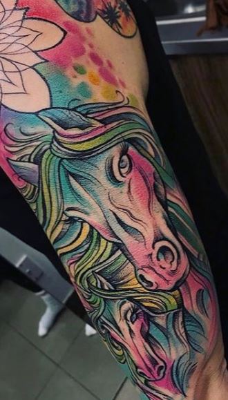 Tattoo of a horse on the shoulder for women