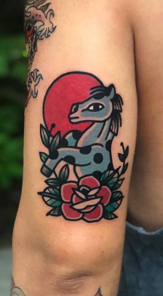 Tattoo of a horse on the shoulder for women