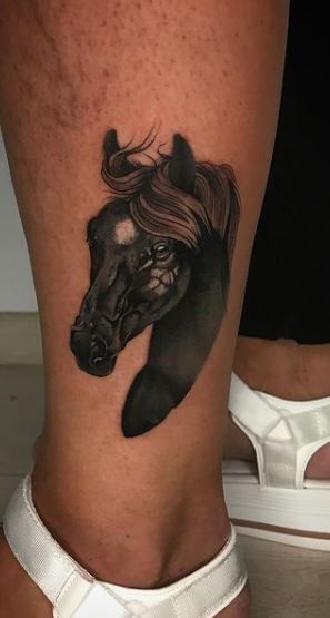 Horse tattoo on the shin for women