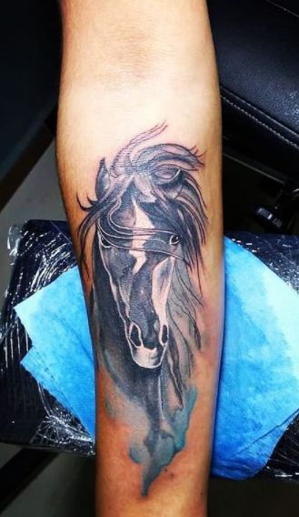 Horse tattoo on the forearm for women