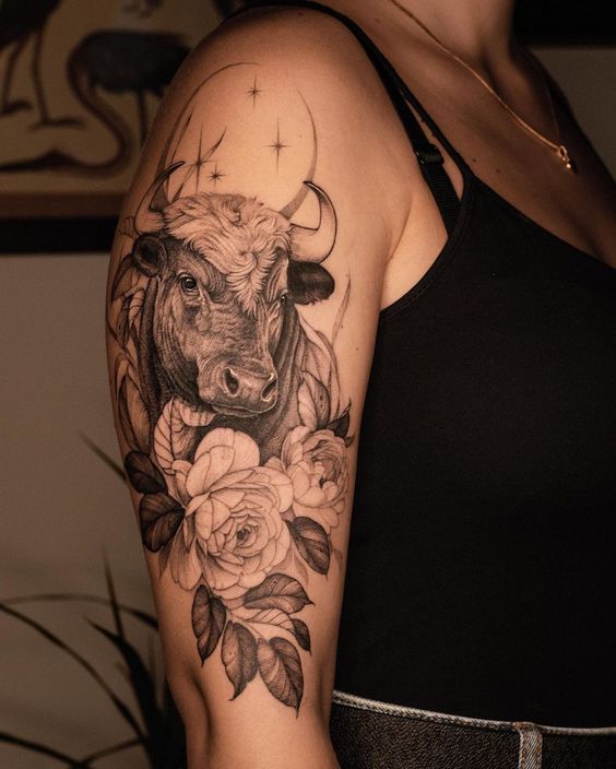 Tattoo of a bull on the shoulder for women