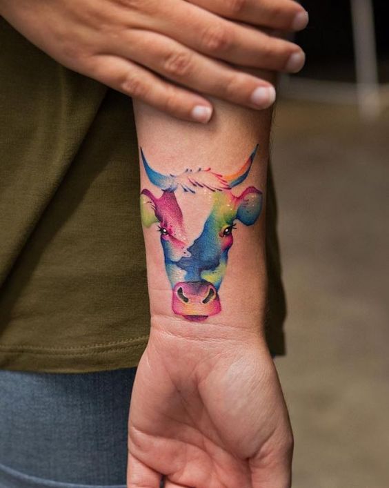 Tattoo of a bull on the arm for women