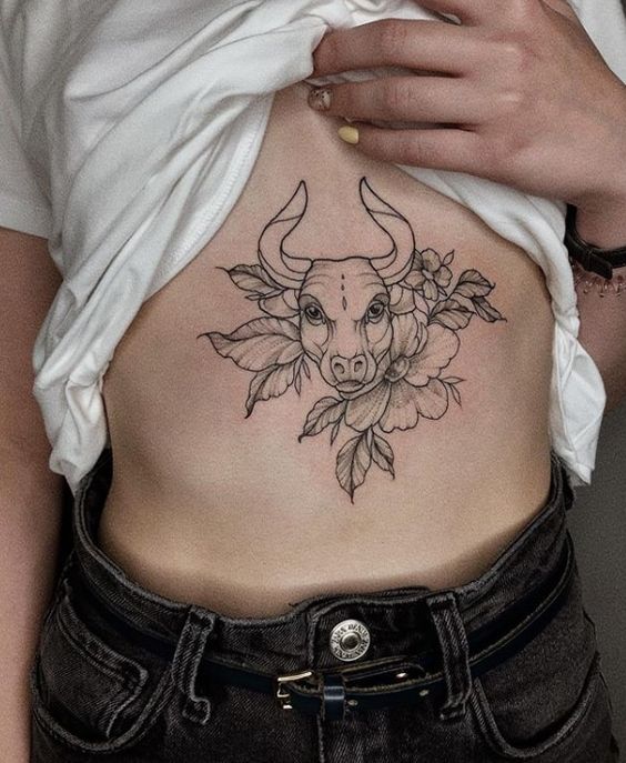 Tattoo of a bull on the stomach for women