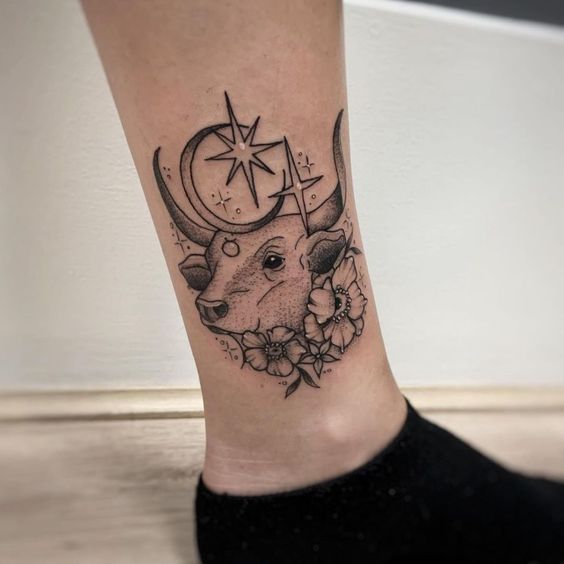 Bull tattoo on the shin for women