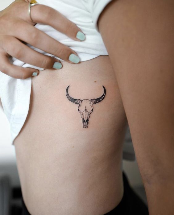 Bull tattoo on the side for women