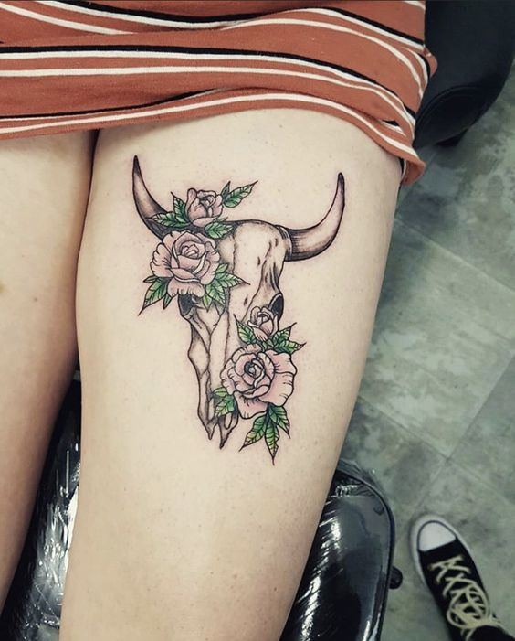 Bull tattoo on the hip for women