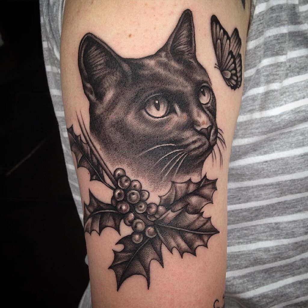 Cat tattoo on the shoulder for women