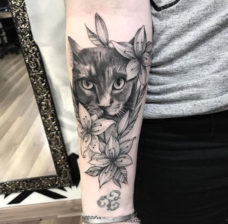 Cat tattoo on the forearm for women