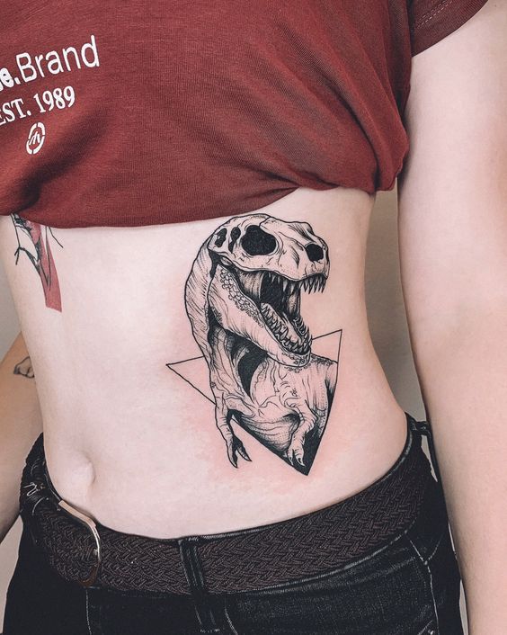 Dinosaur tattoo on the side for women