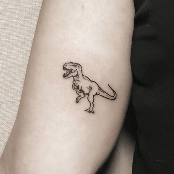 Dinosaur tattoo on the shoulder for women