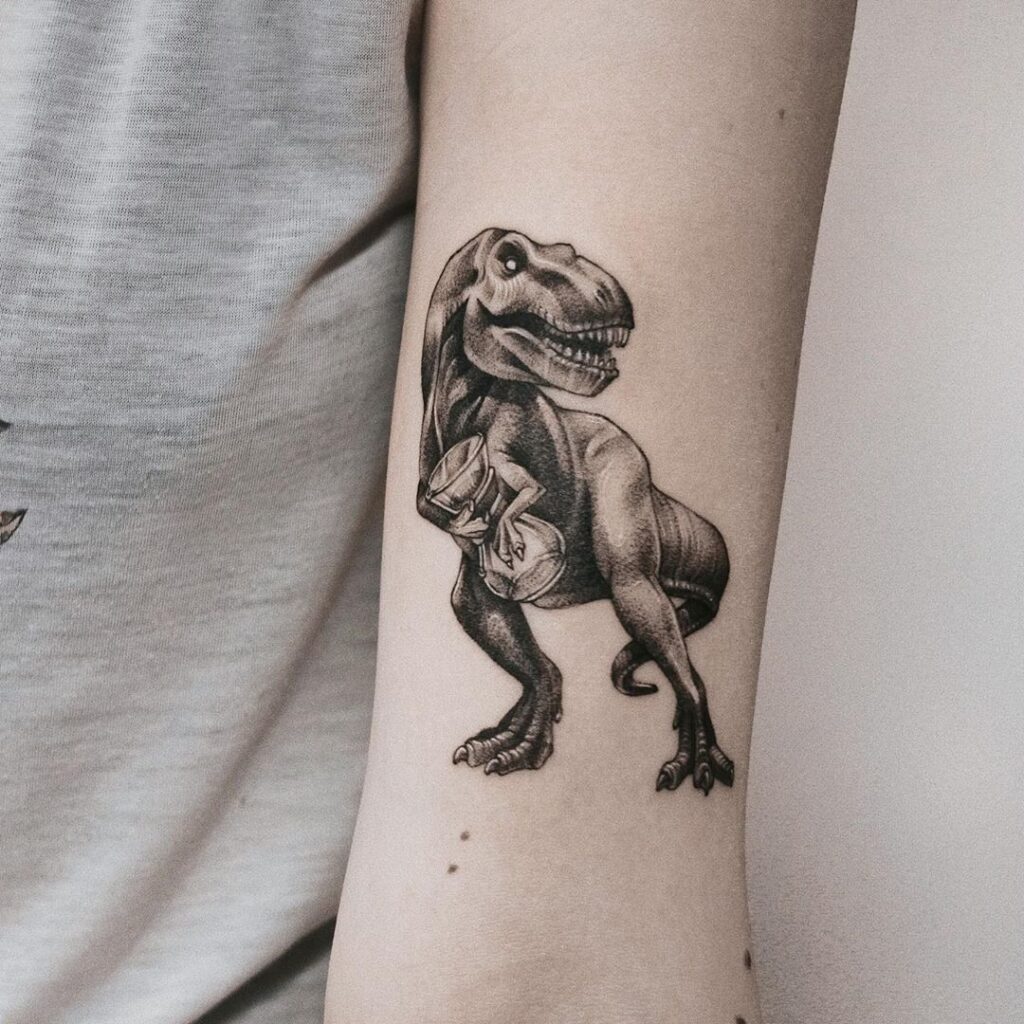 Dinosaur tattoo on the shoulder for women