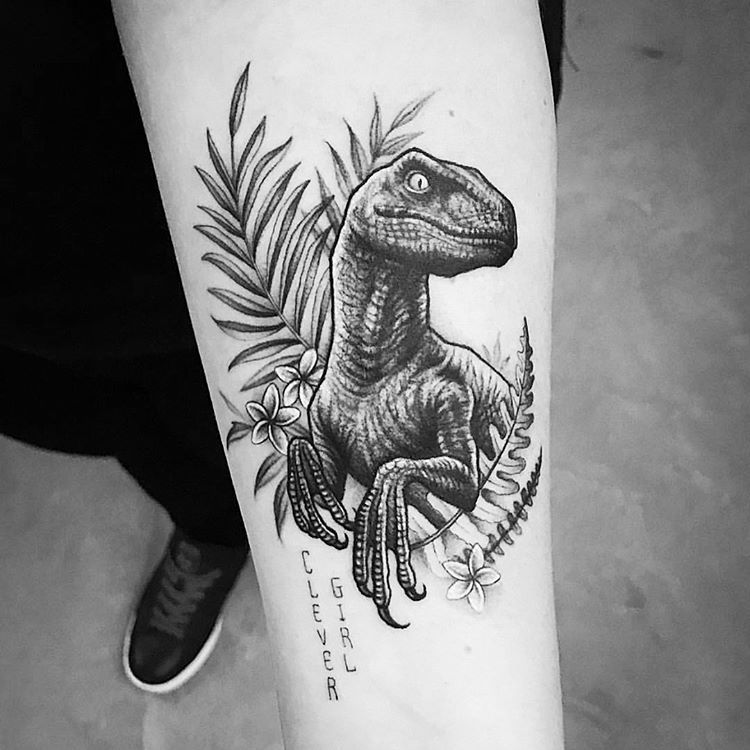 Tattoo of a dinosaur on the forearm for men