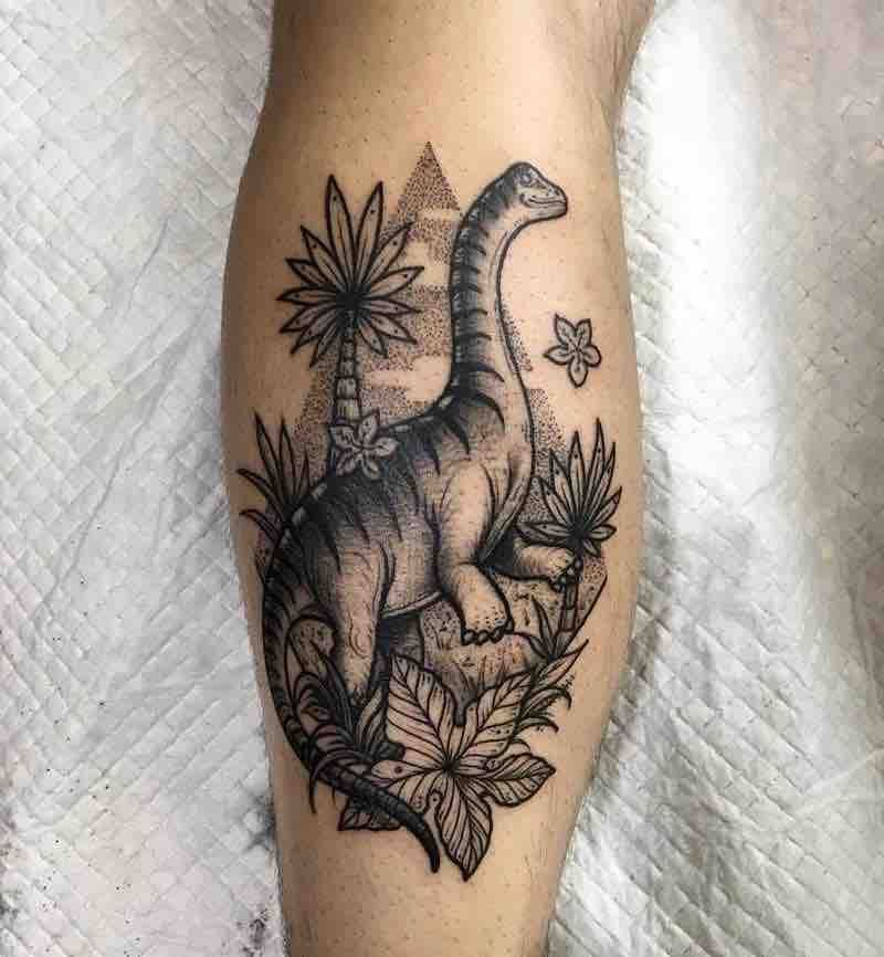 Tattoo of a dinosaur on the shin for men