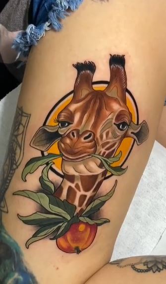 Giraffe tattoo on the thigh for women