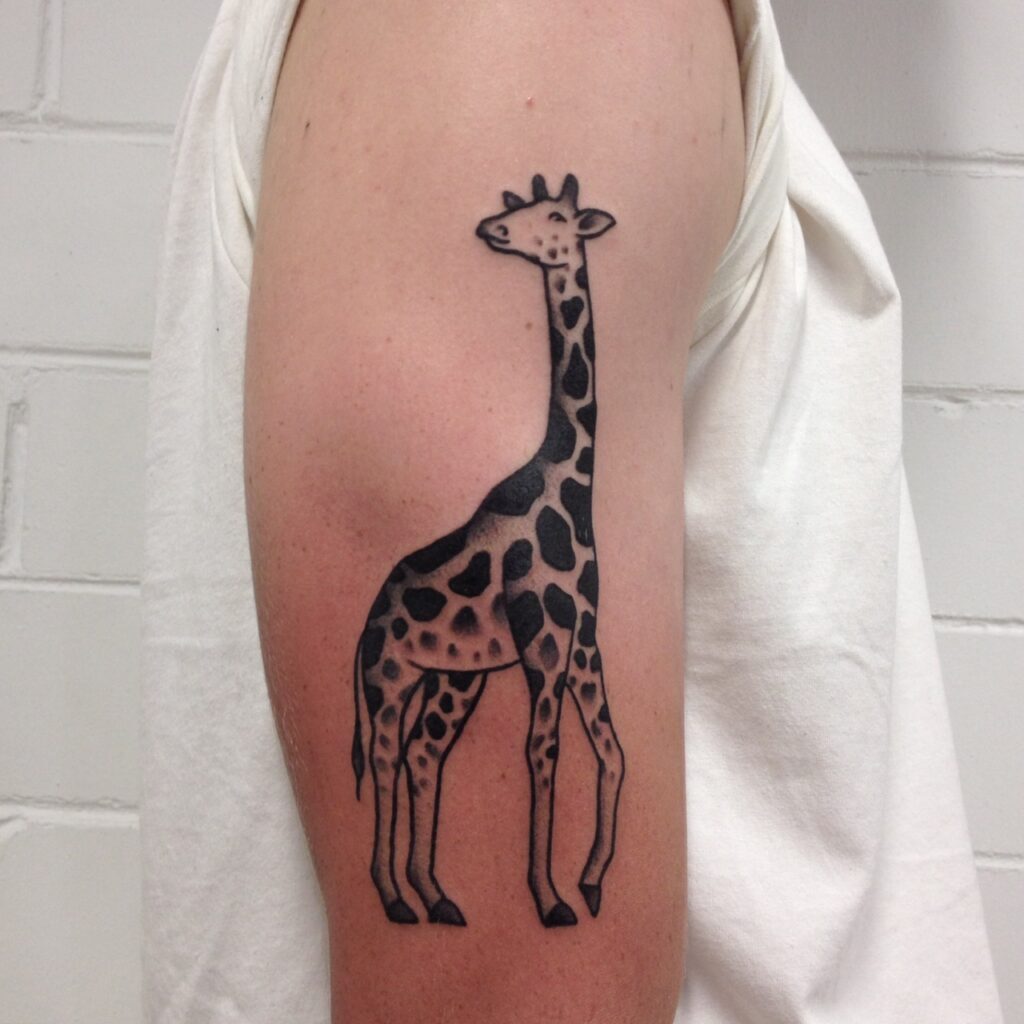 Tattoo of a giraffe on the shoulder for men