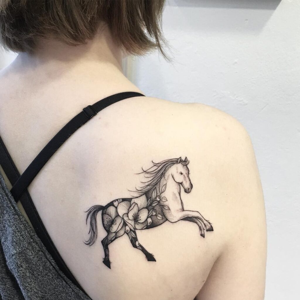 Horse tattoo on the shoulder blade for women