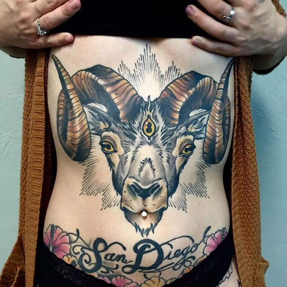 Tattoo of a ram on the stomach for women