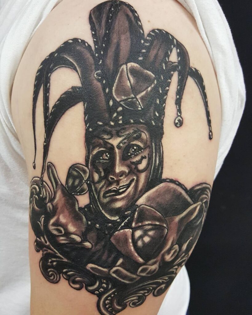 Tattoo of a jester on the shoulder for women