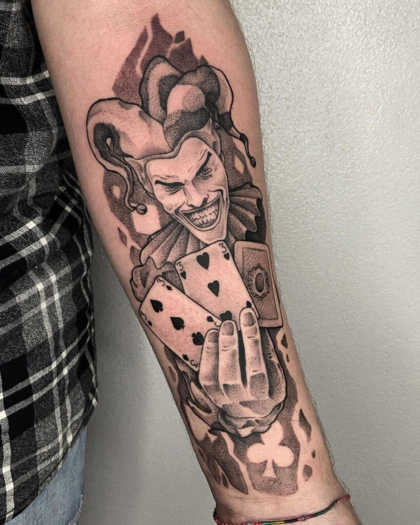 Tattoo of a jester on the forearm for men