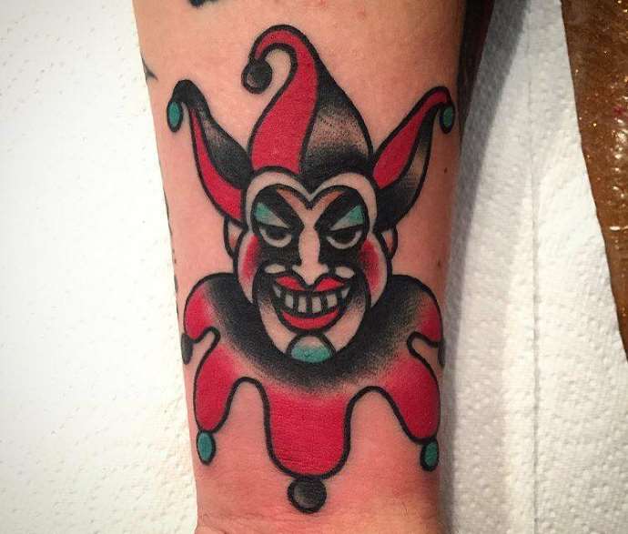 Tattoo of a jester on the arm for men